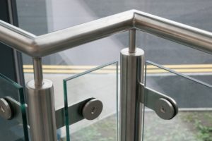 Sturdy silver metal handrail with glass in between